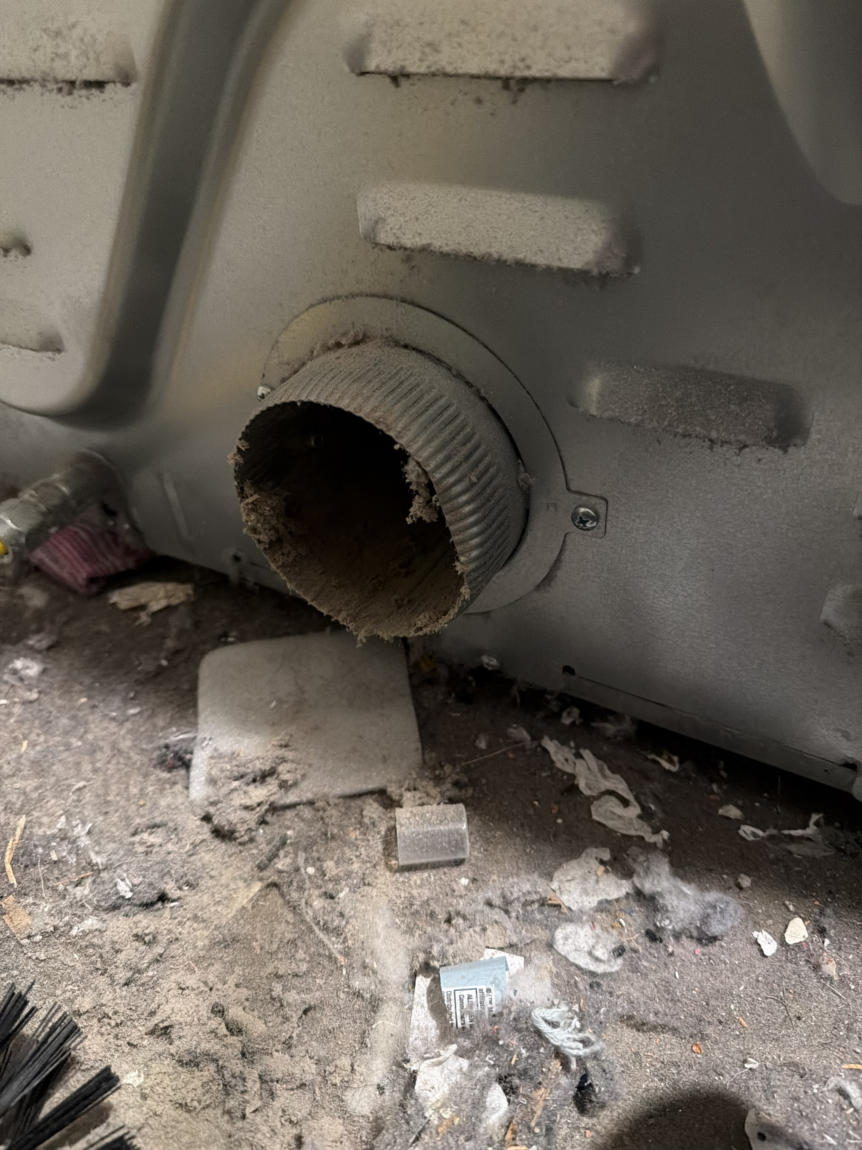 Severely clogged dryer vent interior packed with lint — before cleaning